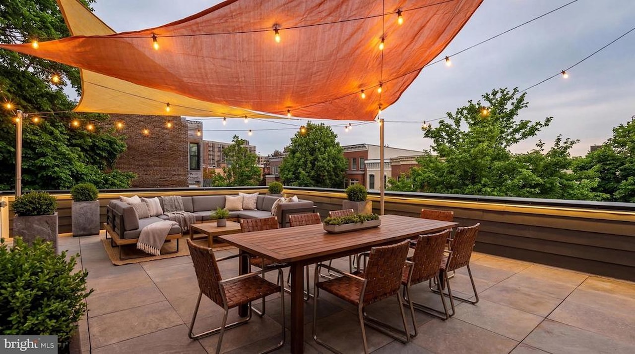 Rooftop terrace with shade sails and string lights