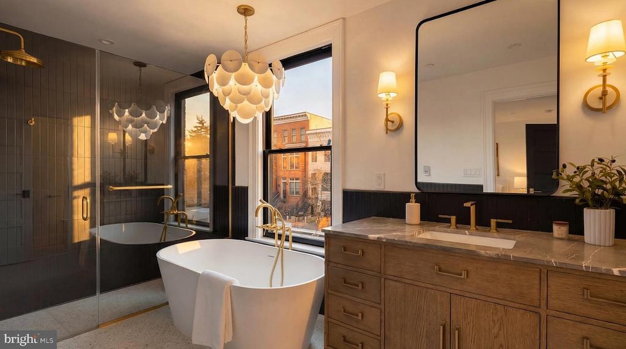 Primary bathroom with freestanding tub and chandelier