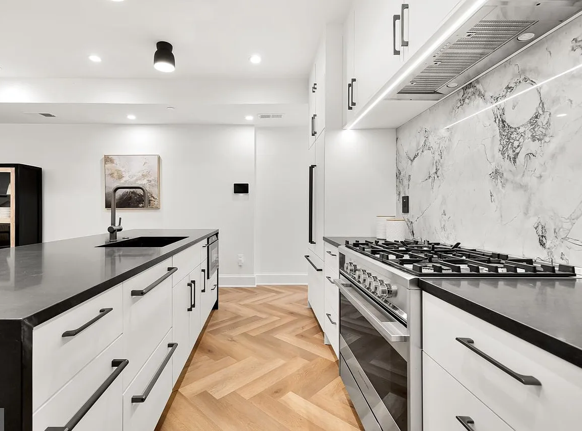Kitchen with marble backsplash and gas range