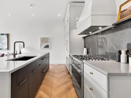 Kitchen with marble backsplash and gas range